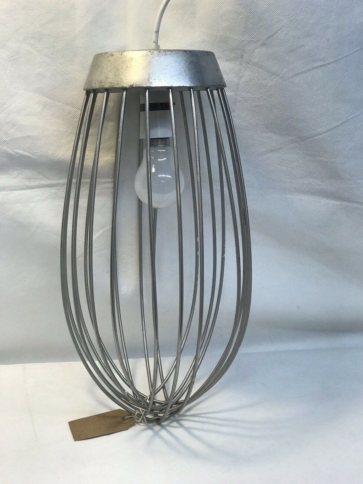 Large Industrial Whisk That Has Been Turned Into A Light Pendant